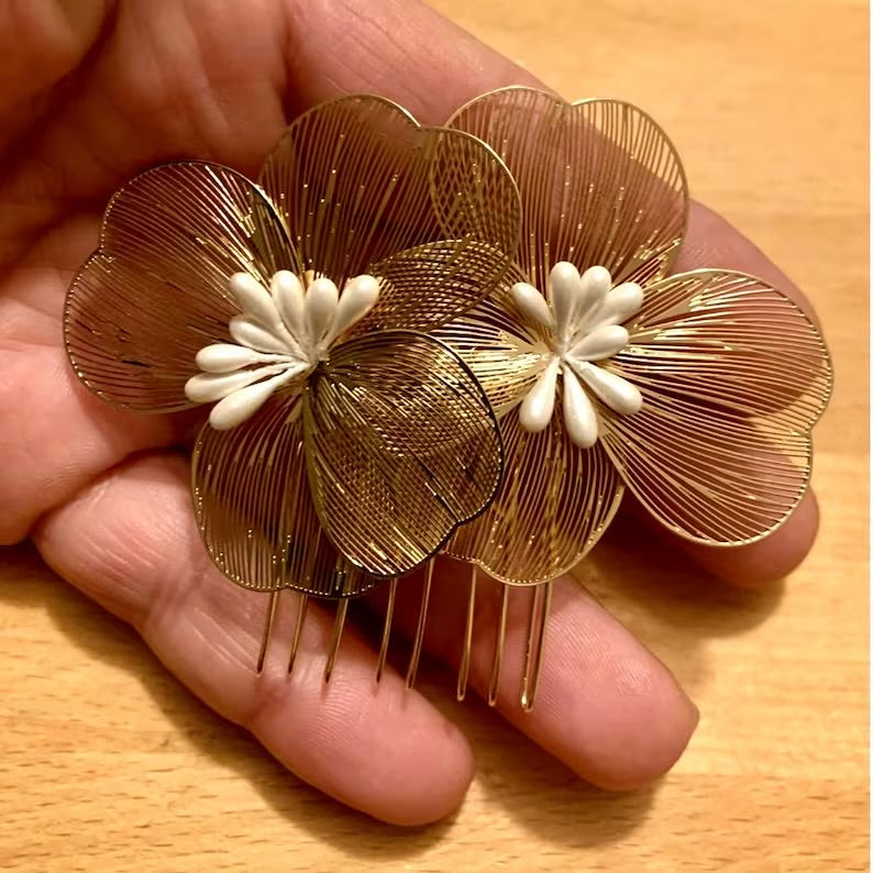 Close-up of Gold Flower Hair Comb held in a hand