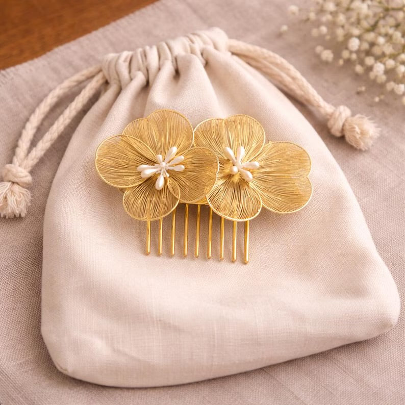 Gold Flower Hair Comb displayed on a fabric pouch