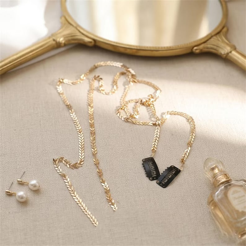 Gold leaf hair vine and clips on a linen surface