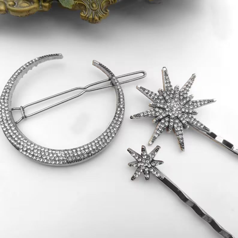 Silver star hair pin detail beside a crescent hair accessory