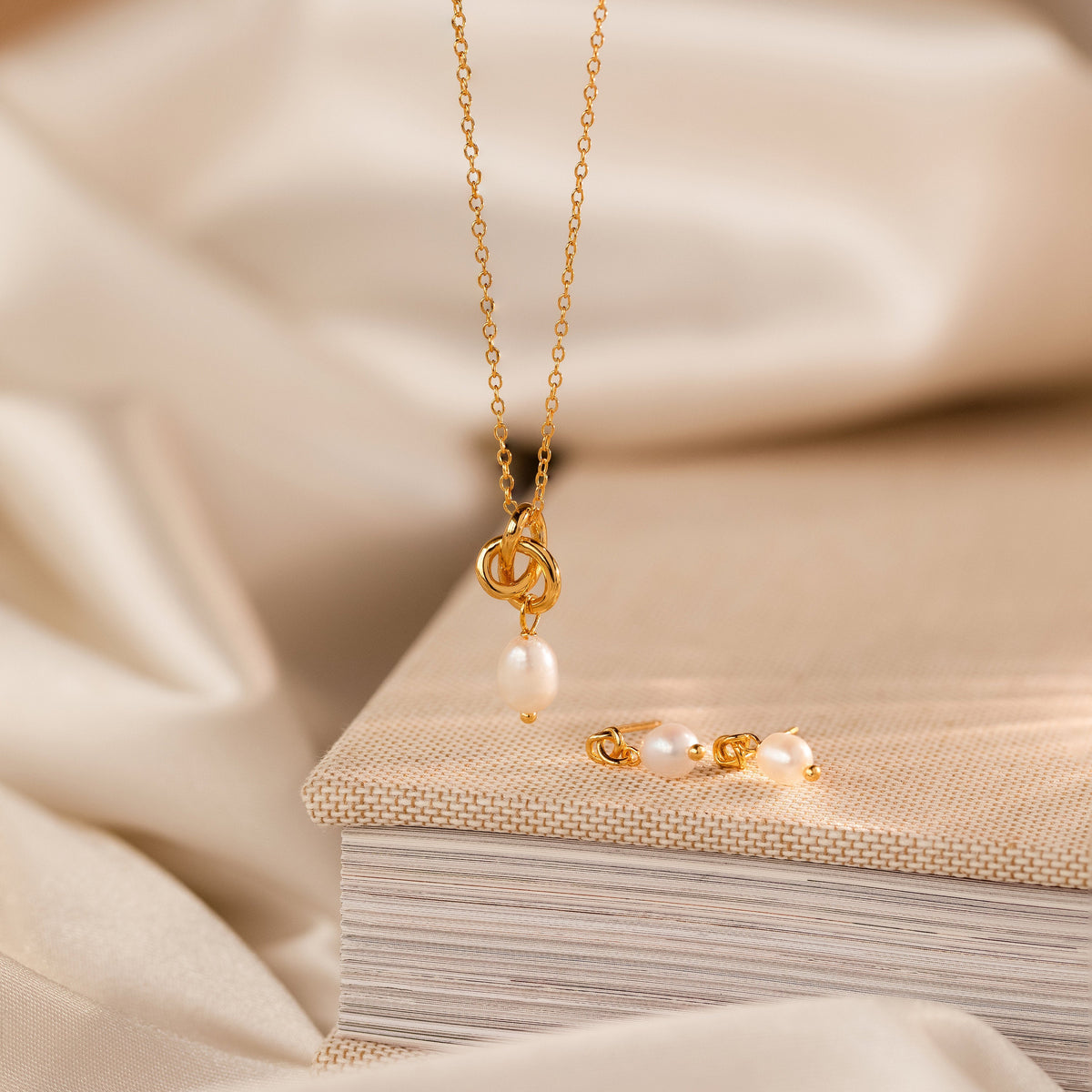 Dainty knot pearl earrings